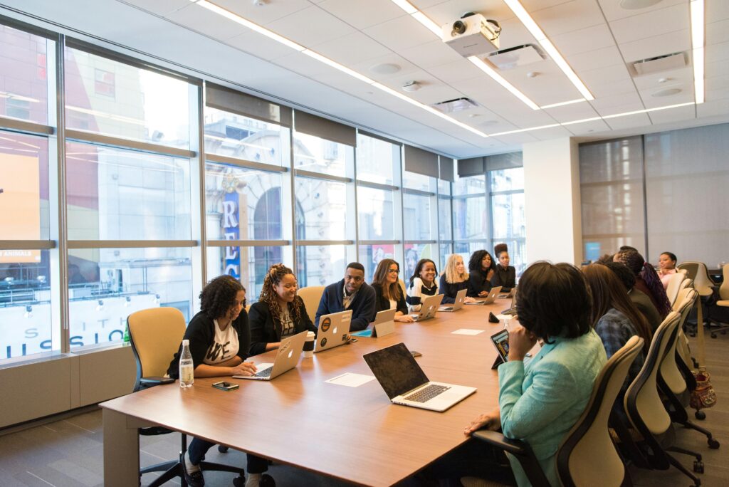 Group of people around a desk with computers